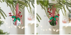 Detail view of white and green Christmas bells with ribbon and berries on tree branches