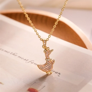 Macro shot of gold-plated duck pendant necklace featuring pink and orange micro-pave zircons