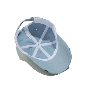 Internal structure of light blue baseball cap showing 6-panel stitching and sweatband