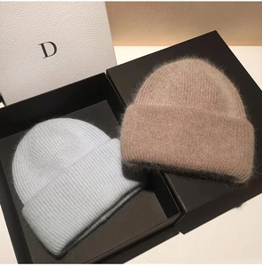 Detailed texture of premium fluffy rabbit fur knit beanies in an elegant gift box