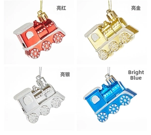 Detail of four colorful train Christmas ornaments in red, gold, silver, and blue with glitter