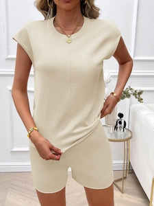 Detail of a beige sleeveless round neck knit top and matching shorts in soft fabric