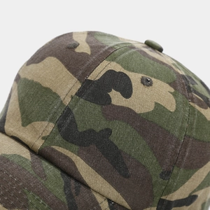 Close-up of jungle camouflage baseball cap fabric showing stitching and breathable eyelets