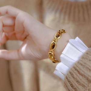 Vintage gold tiger eye stone chain watch with ethnic luxury design on woman wrist