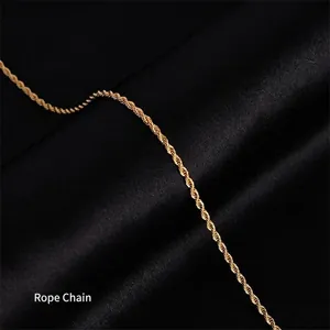 Close-up of golden 18k plated rope chain necklace on elegant black satin fabric