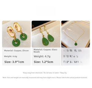 Detail showing green waterdrop glass earrings and necklace with golden plated finish