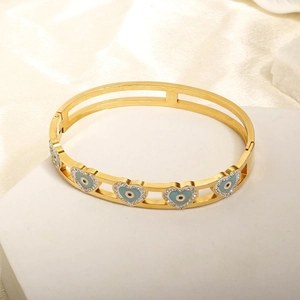 Gold hollow bangle featuring heart-shaped evil eye designs and sparkling crystal accents