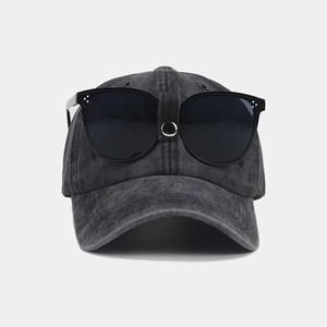 Detail of vintage washed grey baseball cap featuring integrated black sunglasses on top