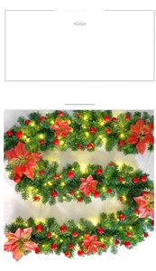 Close-up of 2.7m Christmas vine with red flowers, berries, and LED warm lights