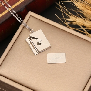 Silver envelope necklace with opening pendant and I love you card on a jewelry box