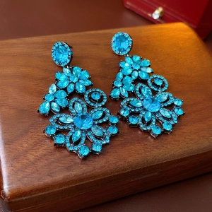 Exaggerated blue crystal flower drop earrings in a luxury long floral design