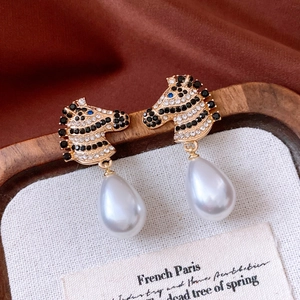 Detail of vintage zebra earring with black and white crystals and large pearl drop