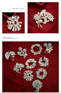 Detailed macro view of gold-tone floral brooches with pearls on dark red silk