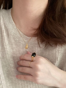 925 sterling silver gold heart necklace and black gemstone ring set worn by a model