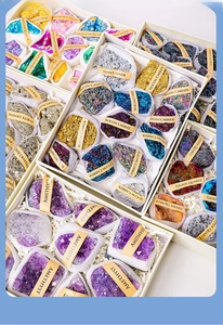 Detail view of natural crystal specimens in individual gift boxes with name labels