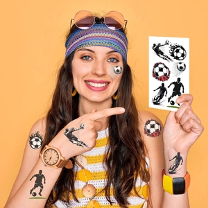 Close-up of soccer themed temporary tattoos on face and arm of a smiling model