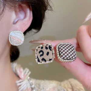 Square fabric stud earrings with rhinestones in houndstooth, leopard, and tweed patterns