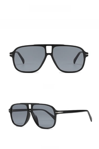 Detail of pilot sunglasses showing black frame, gray lenses and metal arrow temple accents