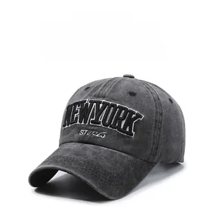 Macro detail of 3D New York embroidery on vintage washed grey cotton baseball cap