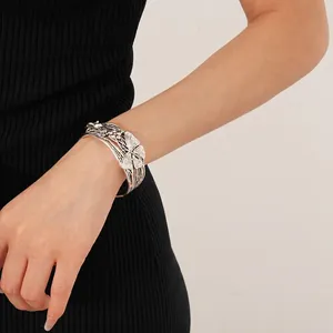 Vintage silver open bangle featuring brushed metal with butterfly and floral engravings