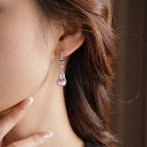 Silver gourd earrings with pink cat eye stone and cubic zirconia shown on model