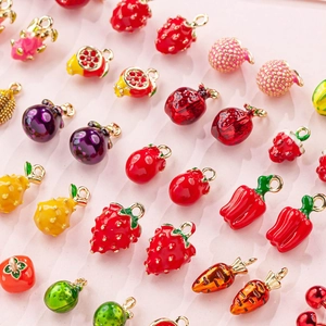 Macro shot of assorted colorful fruit and vegetable enamel charms for DIY jewelry making