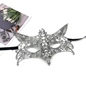 Detail of silver lace masquerade mask with intricate vine patterns and black ribbons