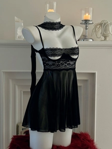 Dettaglio di lingerie nera con scollatura all'americana in pizzo e gonna in rete velata