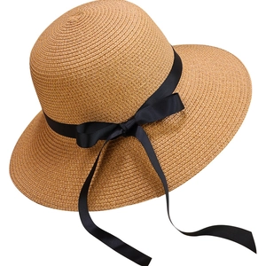 Classic straw sun hat with black ribbon bow and wide brim for summer sun protection