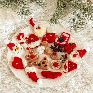 Handmade knitted Christmas ornaments including Santa and Snowman on a ceramic plate