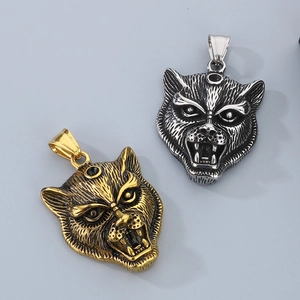 Close-up of gold and silver leopard pendants with black stone and punk animal carvings
