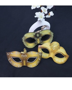 Three golden masquerade masks with glitter patterns on a dark elegant background