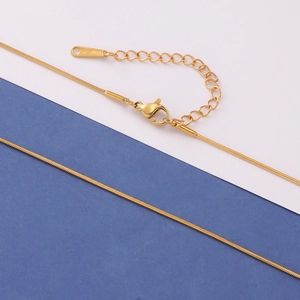 Detail of gold-plated stainless steel snake chain necklace with lobster clasp and extender