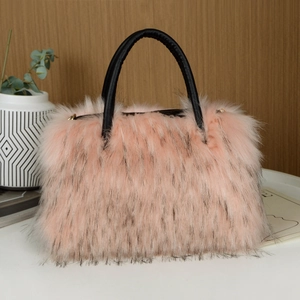 Detail view of a luxury pink faux fur tote bag with black handles in a stylish home setting