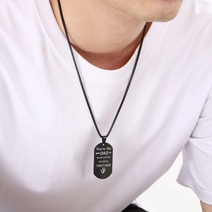 Black stainless steel dad necklace dog tag with engraved text on a male model