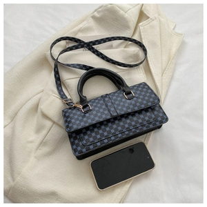 Flat lay of litchi texture handbag with blue geometric patterns and golden hardware