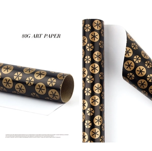 Close-up of 80G black art paper with gold geometric circles and stars for gift wrapping