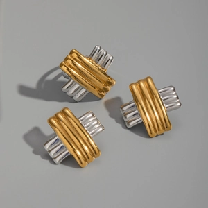 Detailed view of three-piece set featuring gold and silver striped cross weave earrings and ring