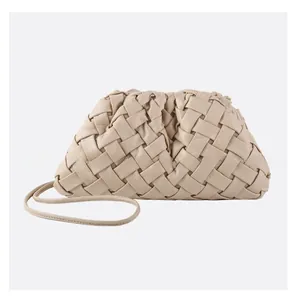 Close-up of beige woven cloud bag featuring intricate diagonal leather braiding and strap