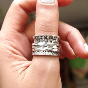 Detailed close-up of vintage silver spinner ring featuring engraved floral textures