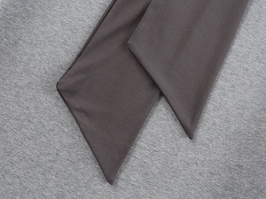 Macro shot of dark grey knit waistband detailing with fine stitching and fabric texture