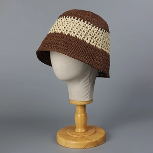 Handwoven bucket hat featuring dual-tone brown and beige straw texture and hollow patterns