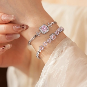 Macro shot of layered pink zircon square bracelets with sparkling cuban chain detail