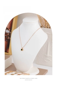 White resin jewelry display mannequin bust for necklaces and pendants in a scenic set