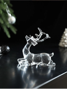 Detailed macro view of a crystal-clear acrylic reindeer ornament in a lying posture