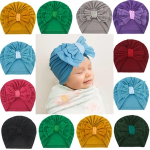 Selection of baby turban hats with large bows in various colors and soft knit fabric