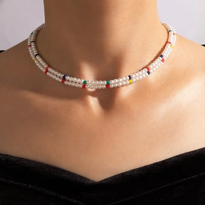 Close-up of double-layered pearl choker necklace with colorful accent beads on model