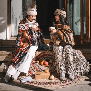 Close-up of knit camping blanket with ethnic geometric patterns and winter accessories