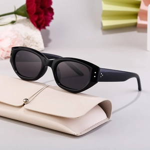 Classic black cat-eye polarized sunglasses on a beige leather case with a 45-degree angle