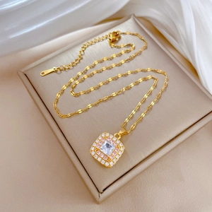 Macro shot of gold-plated stainless steel necklace showing square pink zircon pendant